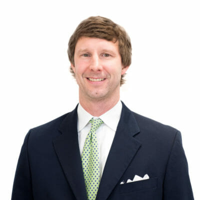 Todd Scruggs of Bank of the James wearing a black suit jacket, white button down shirt, lime green tie and a white pocket square