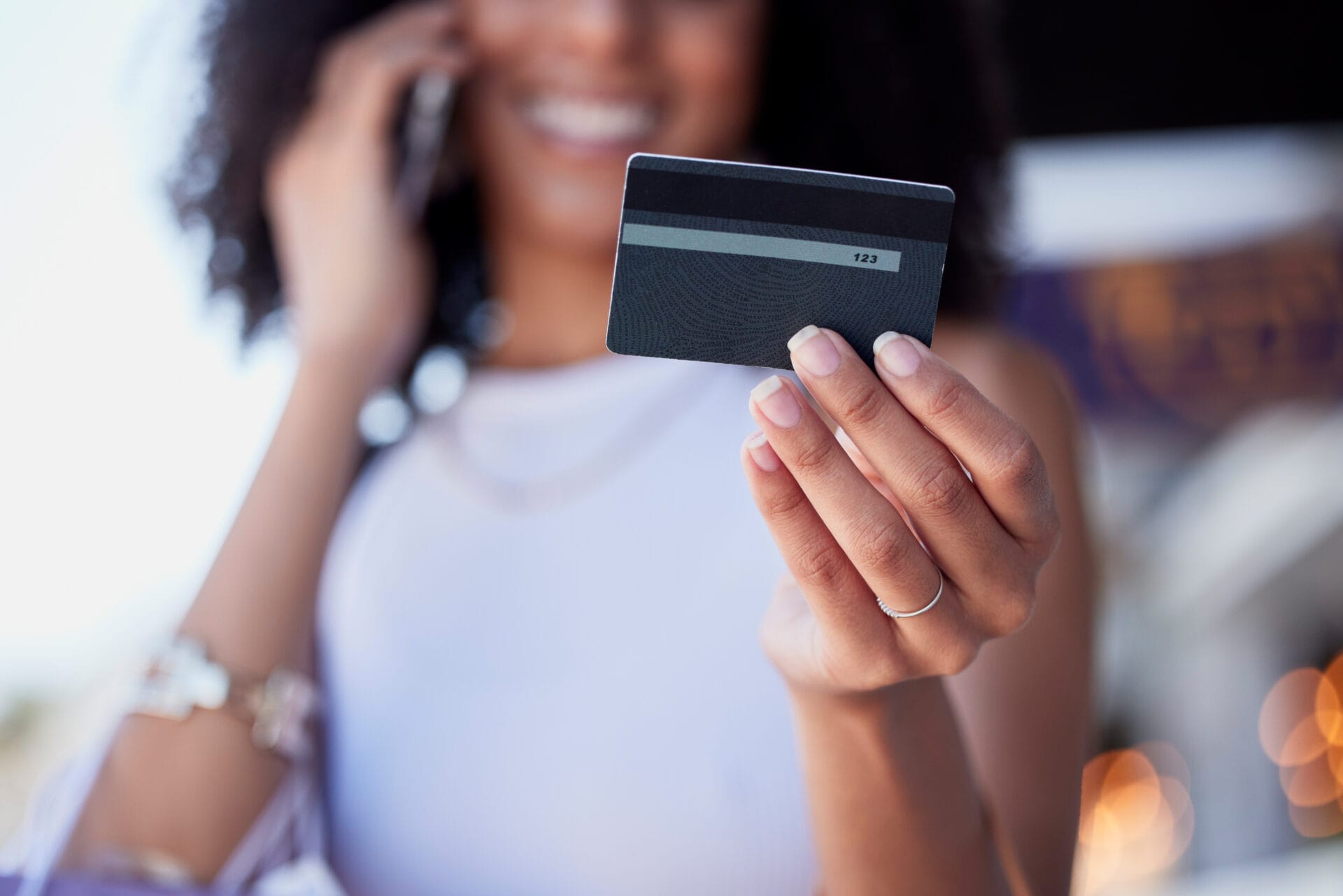 Shopping, credit card and phone call for woman with ecommerce, information and confirmation. Online payment, banking and membership for girl retail customer at a mall while checking credit score.